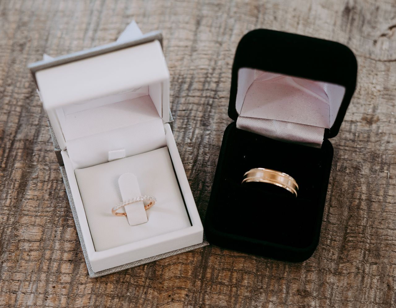 Two wedding bands in two different ring boxes