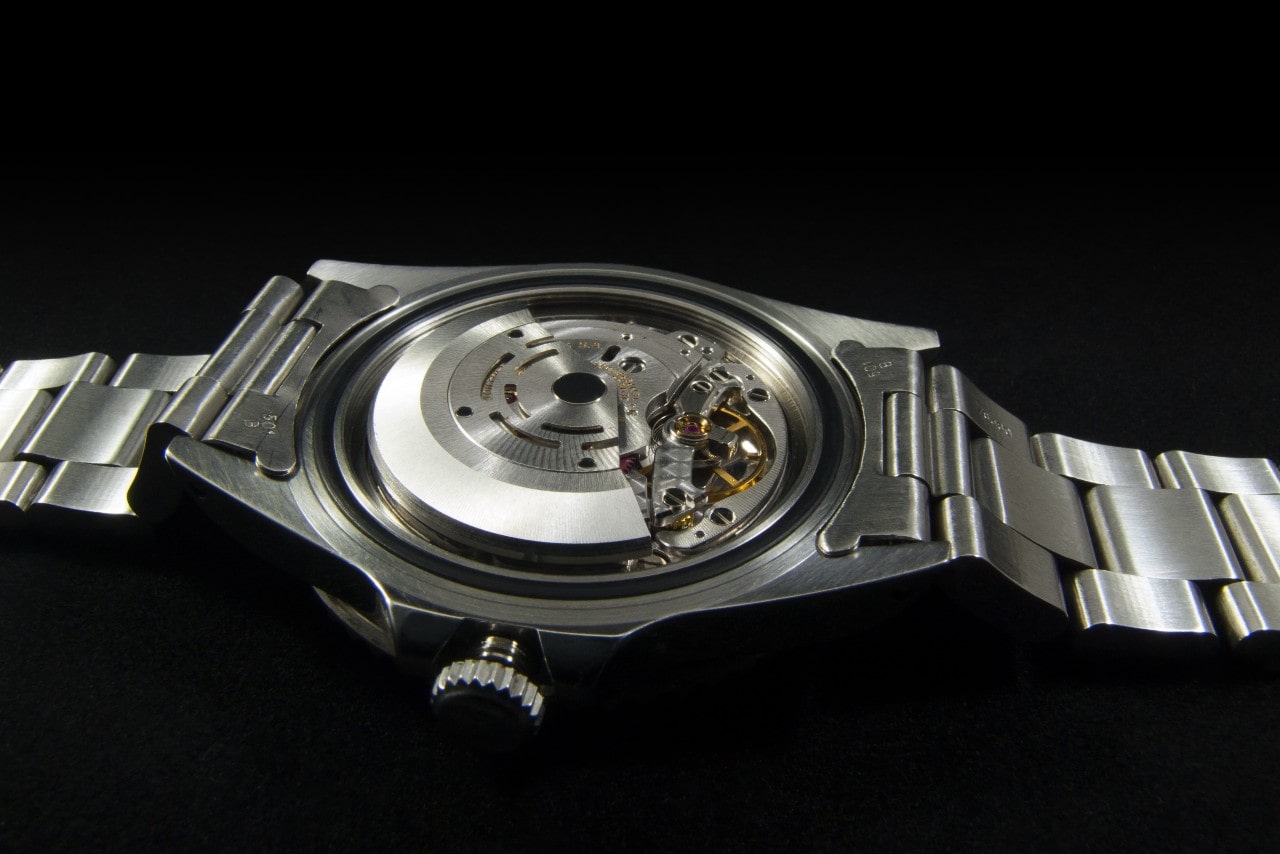 A reverse view of a stainless steel watch