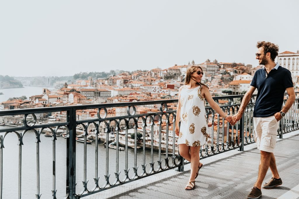 A couple walking along a bridge over water