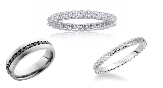 three white gold eternity wedding bands, two featuring clear diamonds, one featuring black diamonds