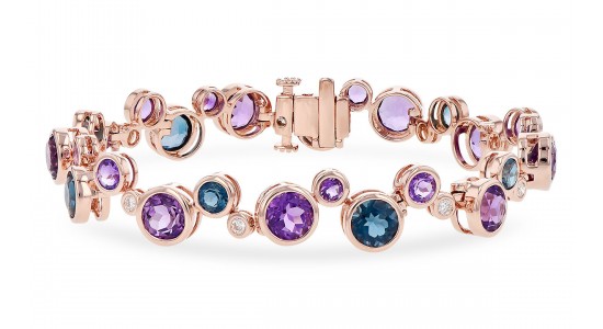 a rose gold bangle bracelet featuring white, blue, and purple gemstones
