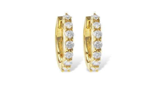 a pair of yellow gold huggie earrings with diamond accents