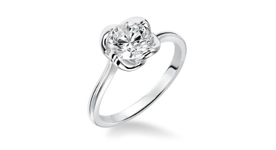 A white gold solitaire engagement ring with floral setting, available at Pucci’s Jewelers.