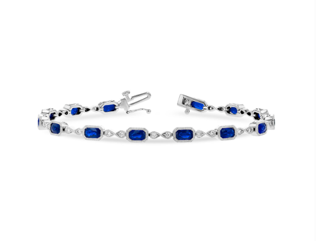 A white gold bracelet with emerald cut sapphires and round cut diamonds