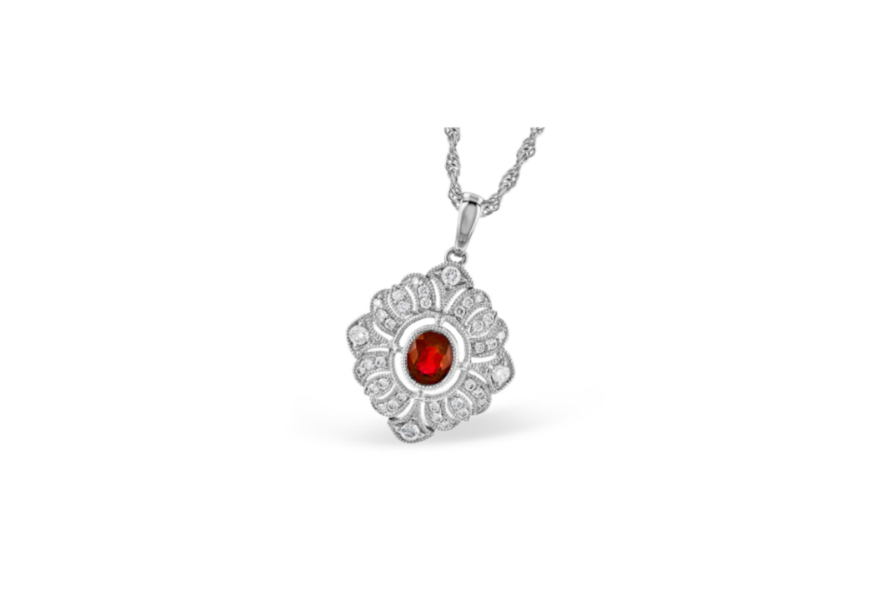 A white gold ruby and diamond pendant necklace.