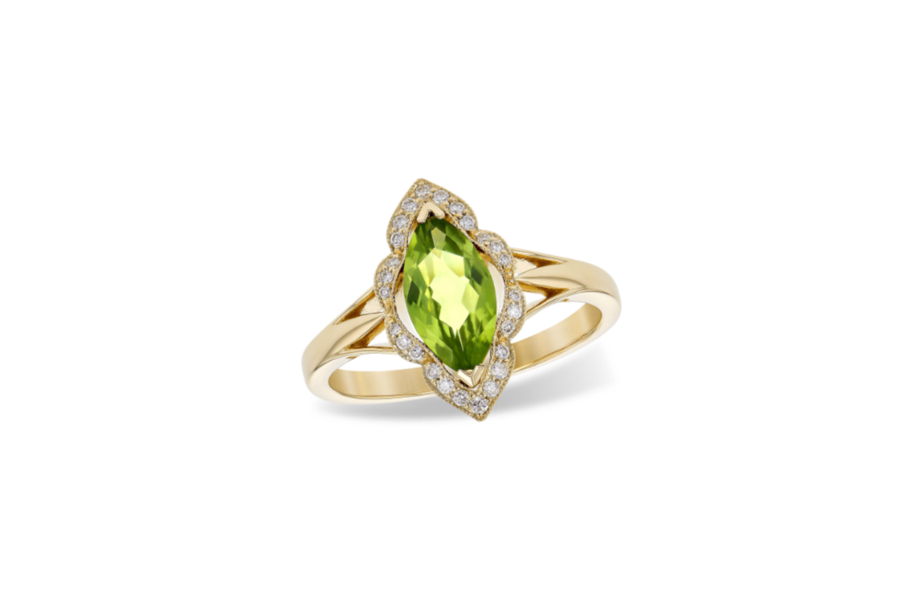 A yellow gold peridot and diamond fashion ring.