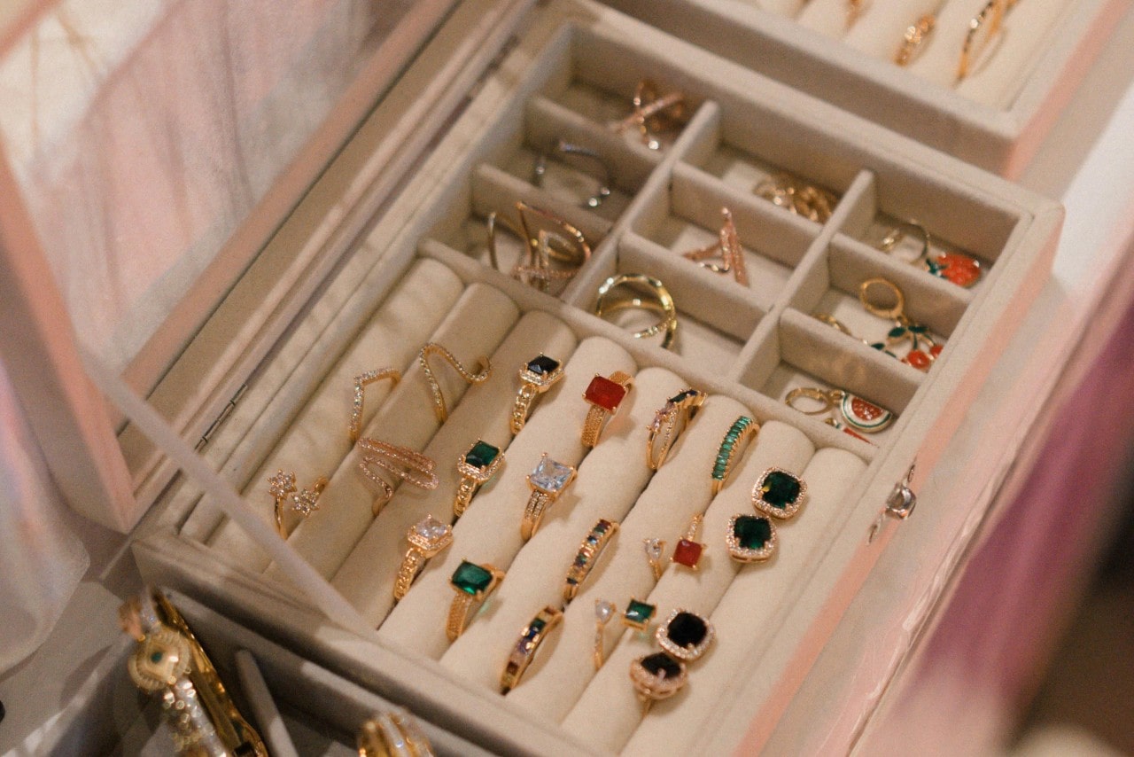 A jewelry box full of colorful gemstone jewelry.